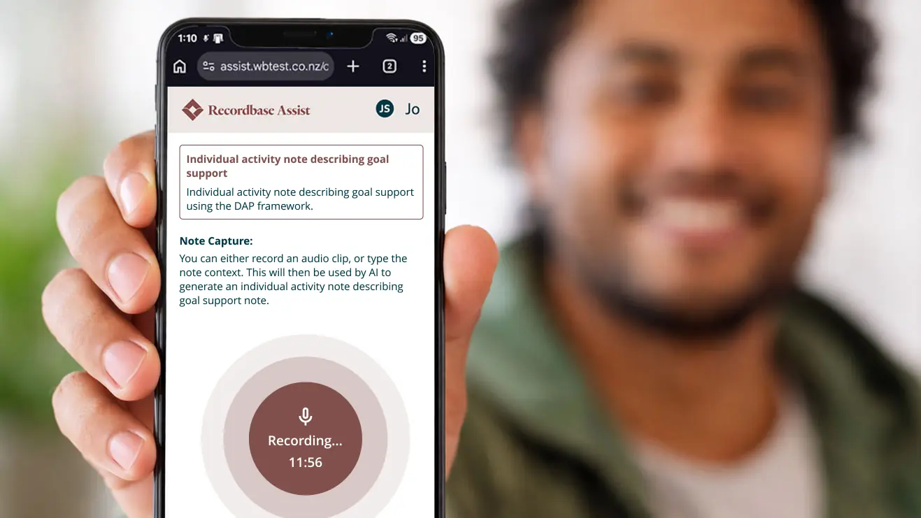 Man holding up phone with Recordbase assist on the screen